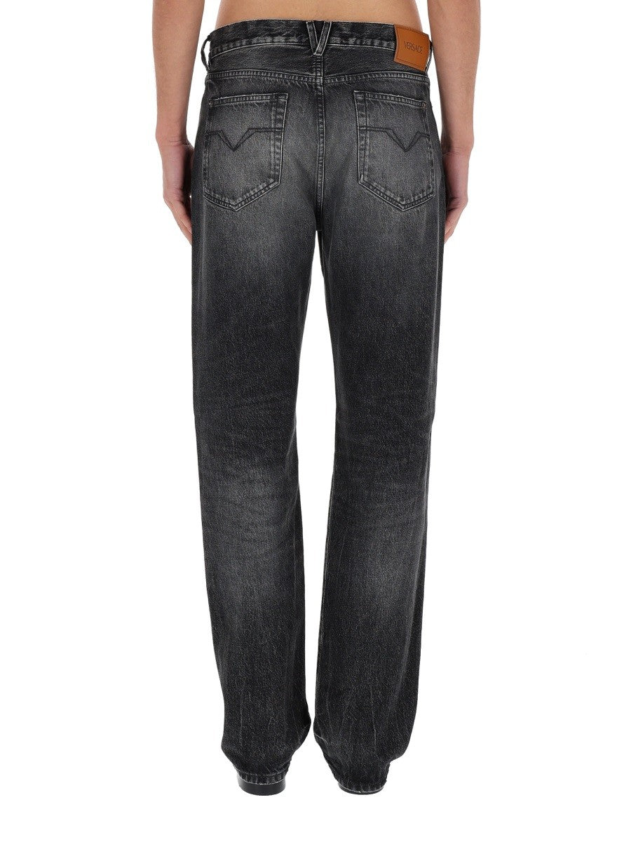 JEANS WITH "MEDUSA" DETAIL