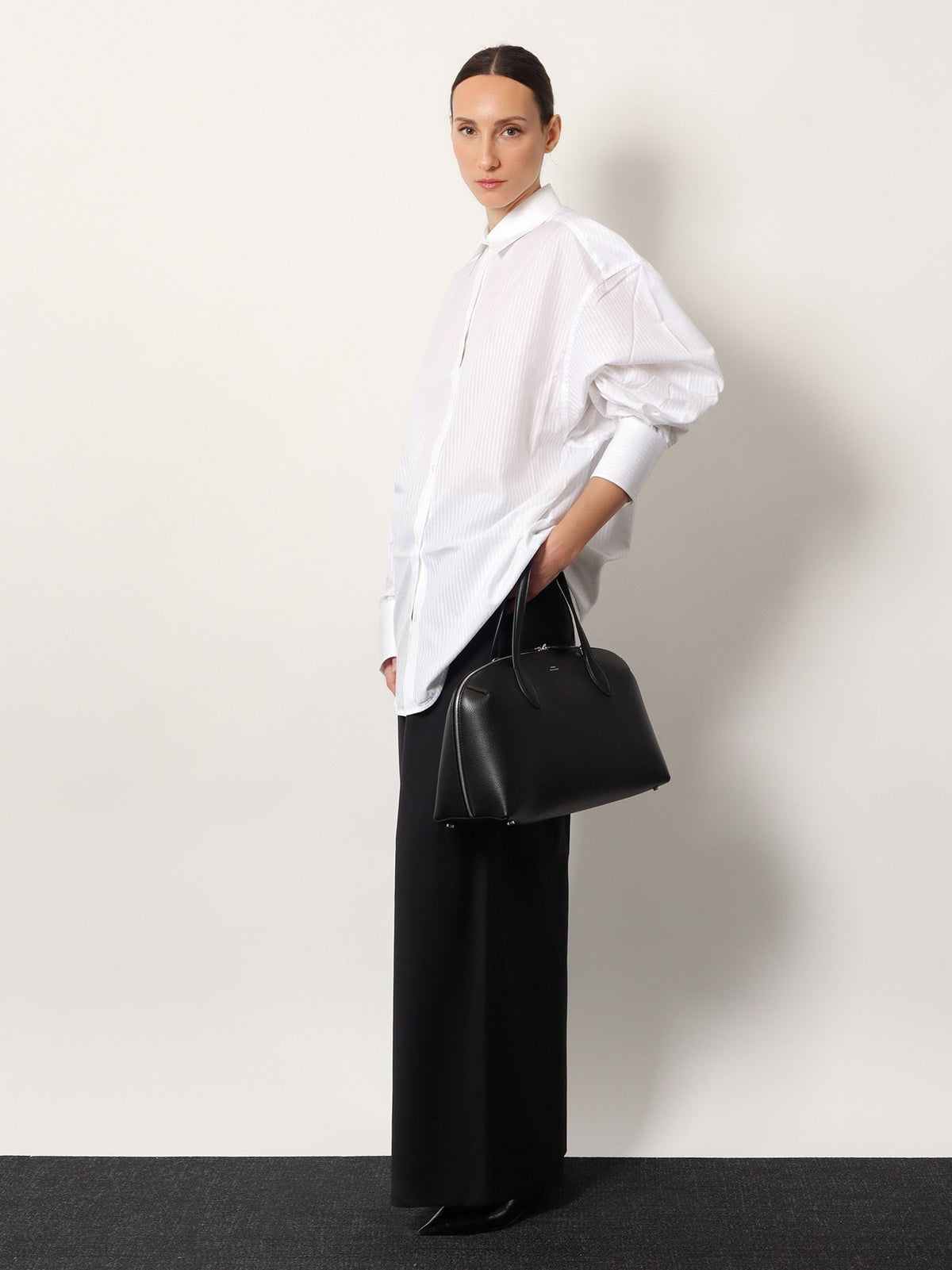 Leather handbag with engraved logo on the front