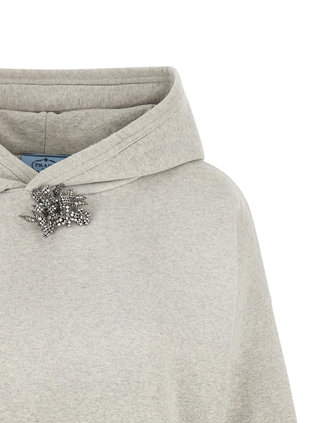 Sweatshirt with jewel pin